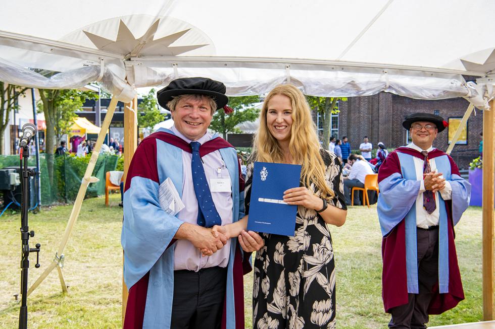 Student receiving graduation certificate  