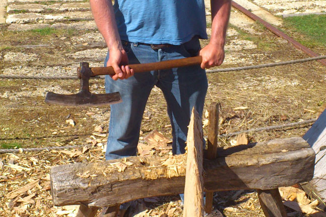 A person holding a broadaxe A person holding a broad axe