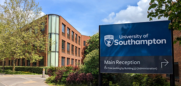 University of Southampton blue sign in foreground with foliage and building 37 behind.