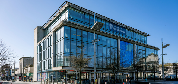 Large glass fronted building in Guildhall square with the Southampton University branding