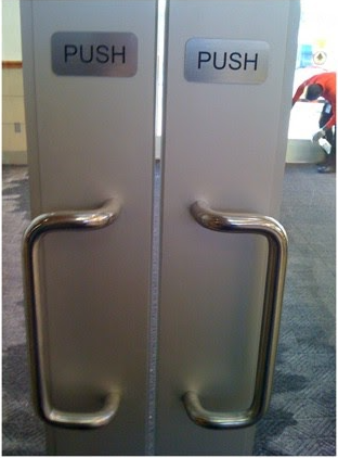 An example of The Norman Door: the signs say 'push' but there are large handles implying the doors should be pulled.