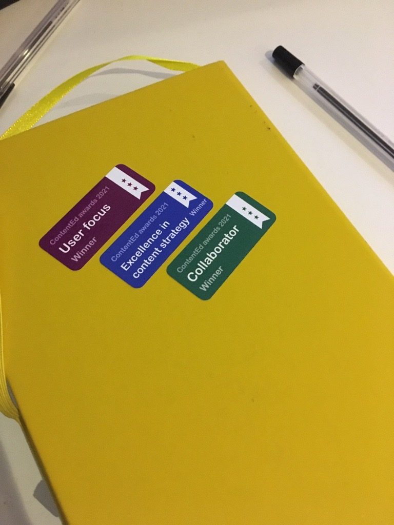 Special award winning stickers to the team following ContentEd awards. White text on purple, blue and green stickers.: User focus, excellence in content strategy and collaborator winner for 2021. 