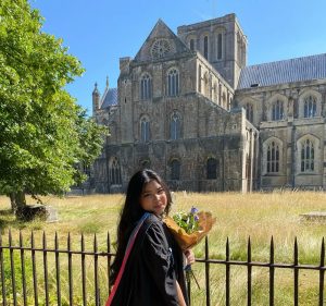 Charisma on graduation day in front of Winchester Cathedral
