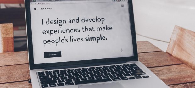 A laptop with the statement 'I design and develop experiences that make people lives simple.'