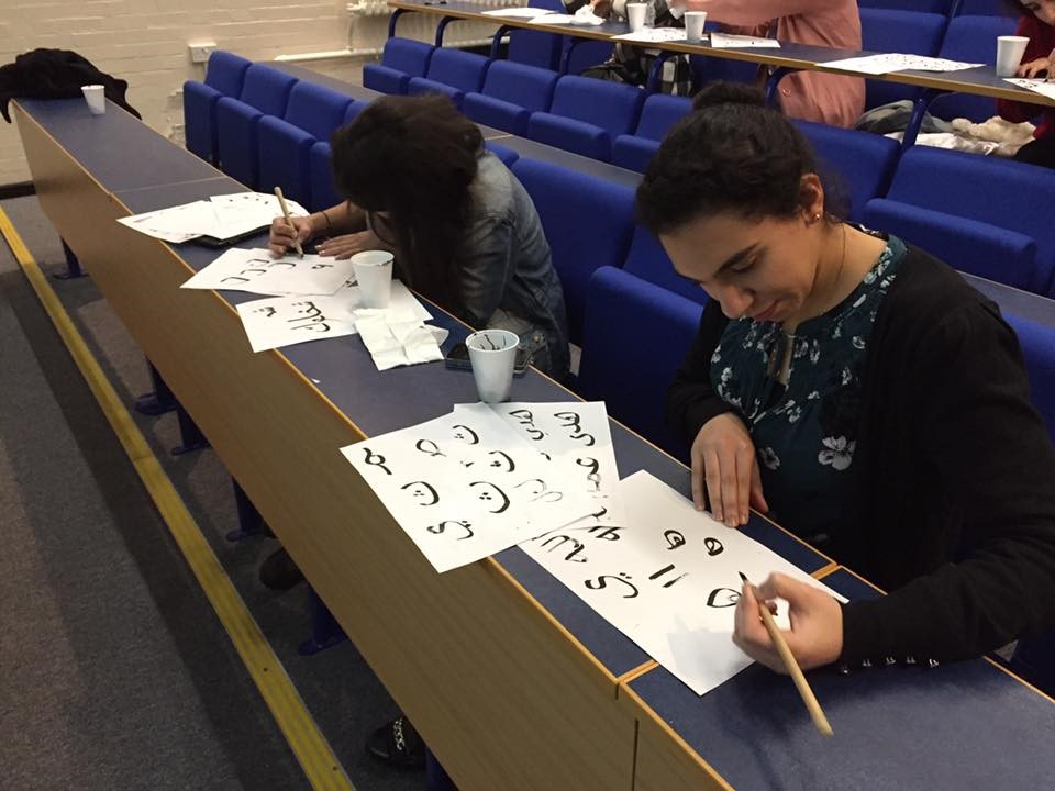 Students at the University of Southampton try their hand at calligraphy.