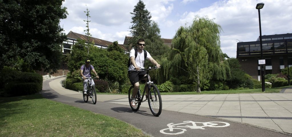 Two cyclists cycling in the University of Southampton's Highfield Campus.