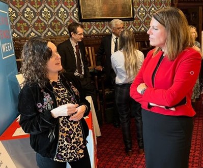 2 women talking at a biological sciences outreach event