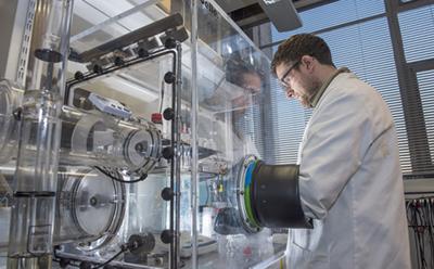 Chemist using a fume cupboard