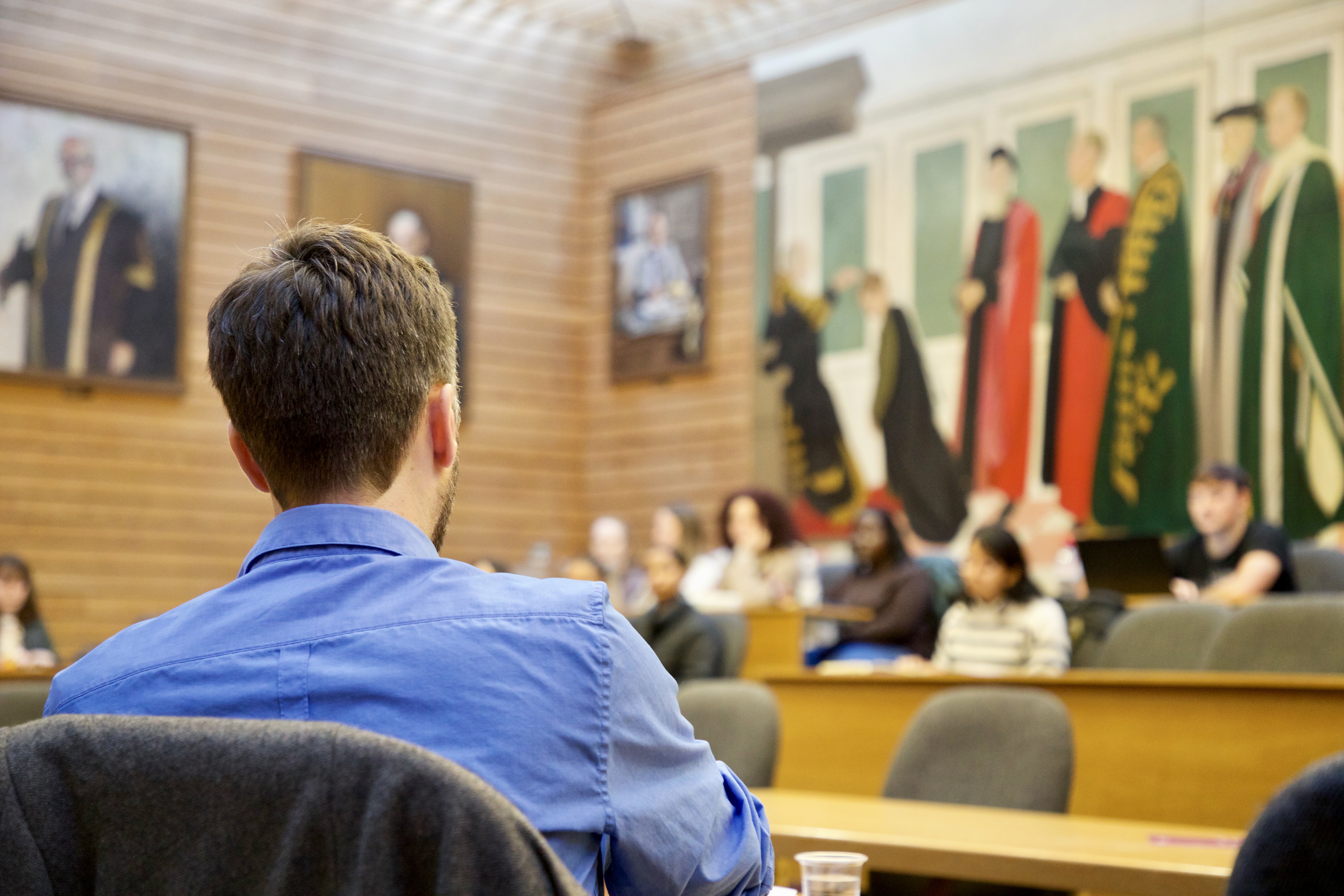 Harry Annison facing students talking