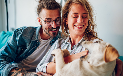 Couple petting dog