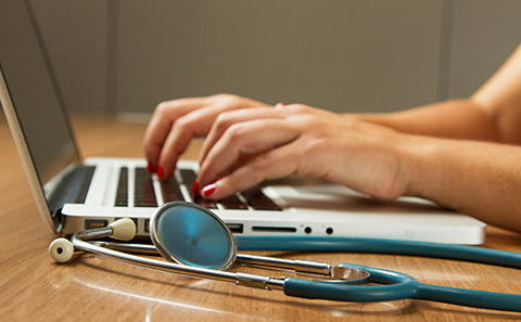 Doctor working on laptop
