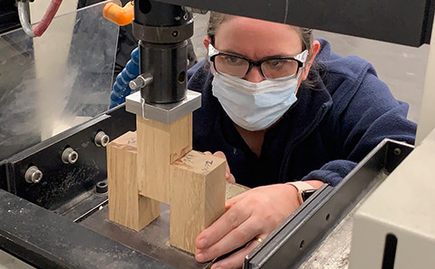 Dr Nicola Symonds setting up a shear test on a glue sample.