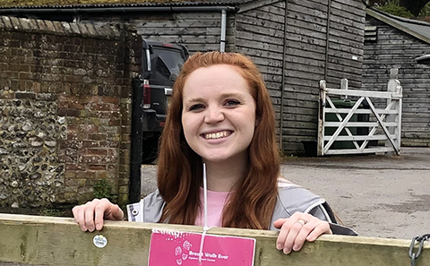 Woman smiling and leaning on gate