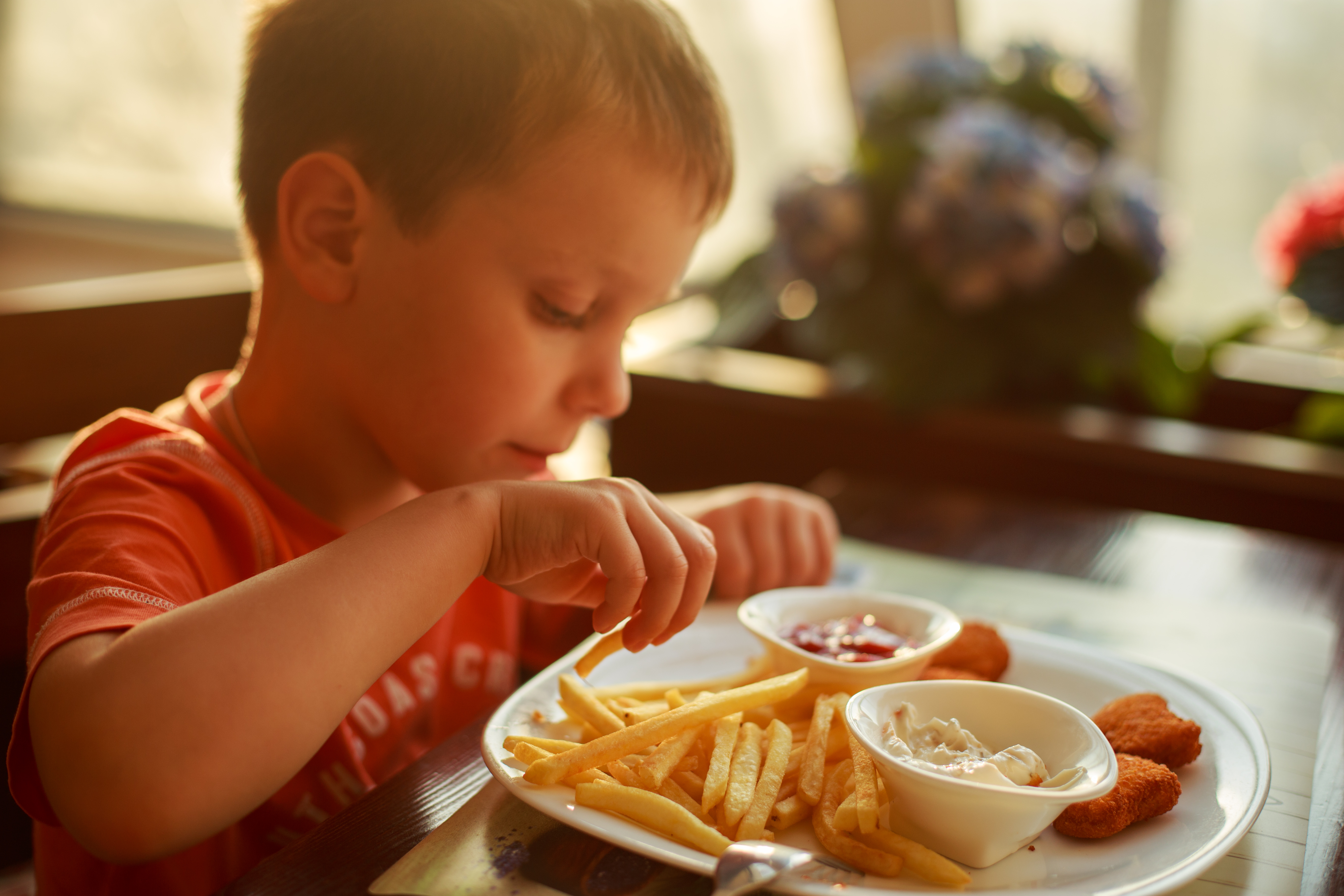 Young boy eating unhealthy food
