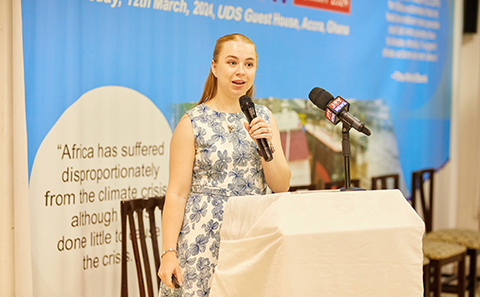 Woman standing, holding microphone