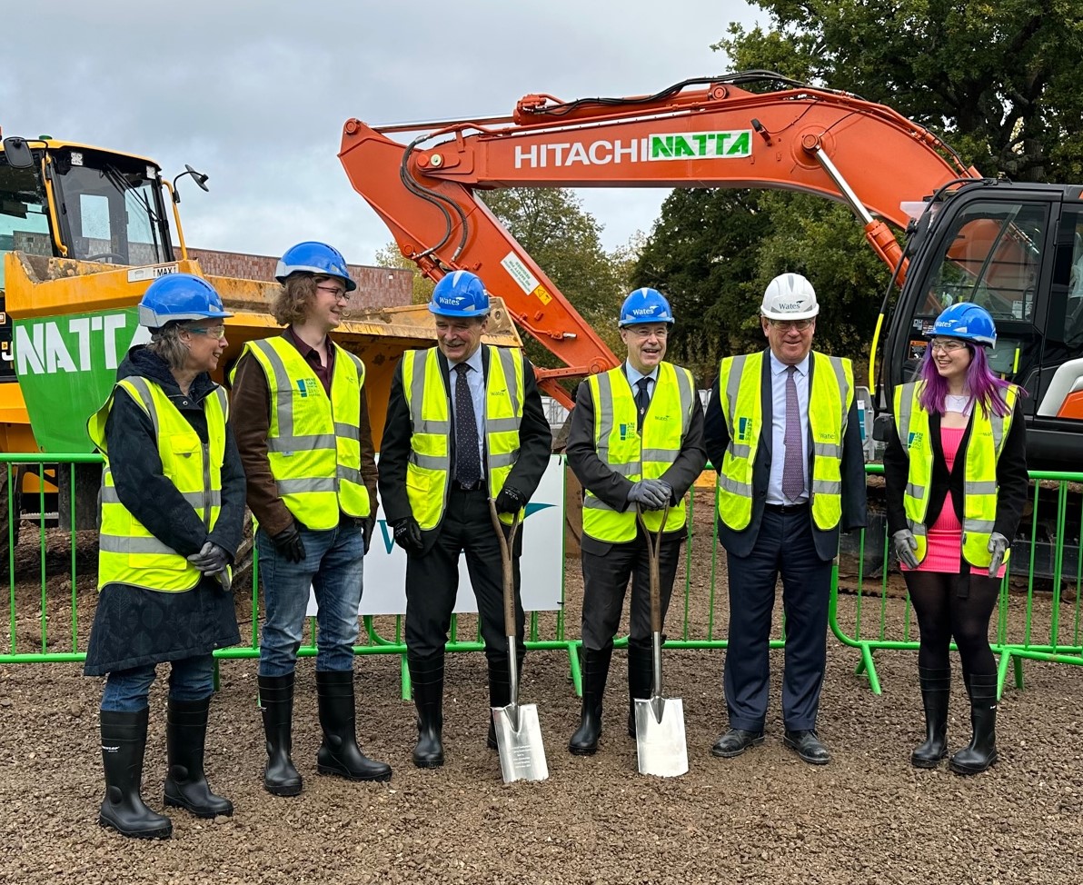 Group of people stood in front of construction at Jubilee Sports Centre