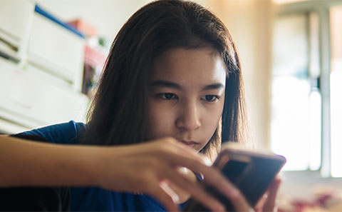 Teen girl looking at phone