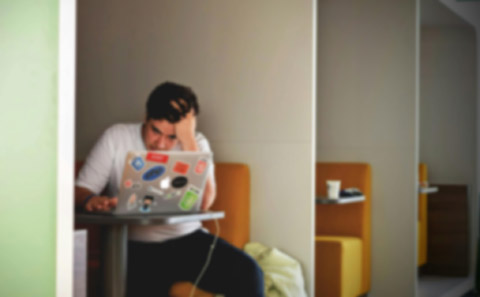 Man with laptop looking worried
