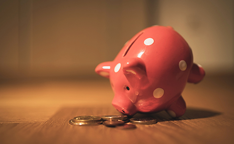 Money spilling out of piggy bank