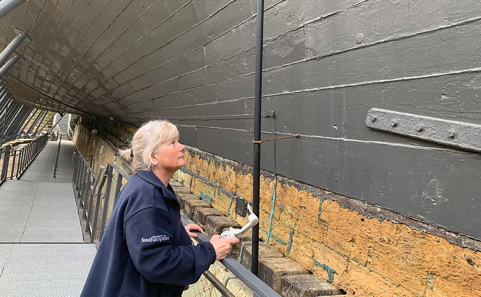 Samantha Hambrook examining hull of HMS Victory.