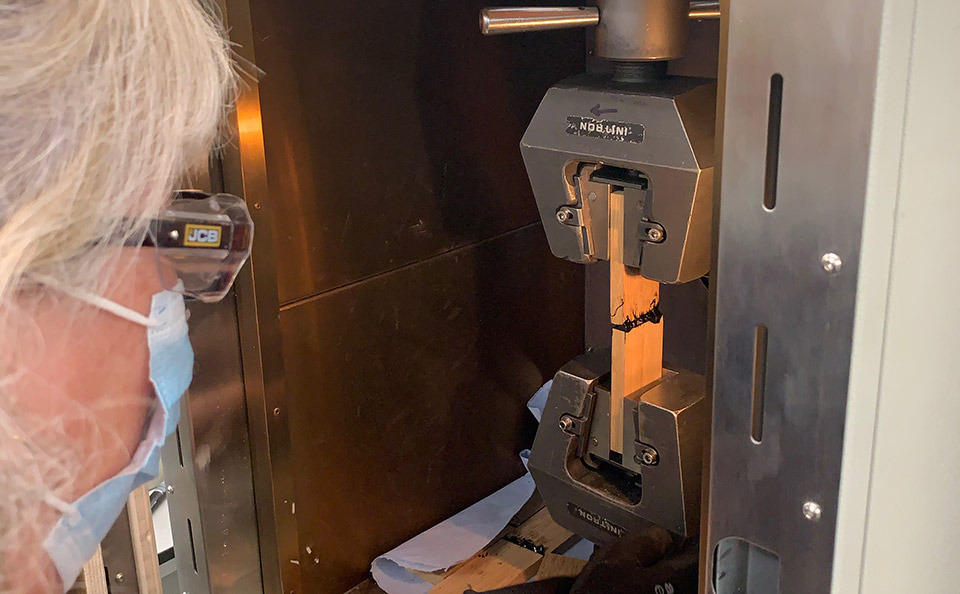 Samantha Hambrook setting up a 70 degree tensile pull test on a caulking sample.