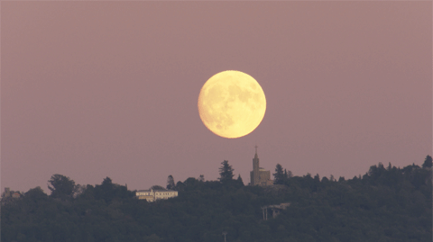 moon in sky over town