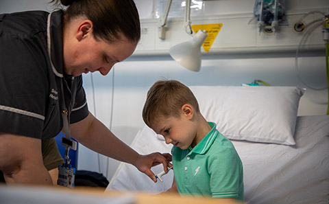 Boy in green t-shirt with nurse