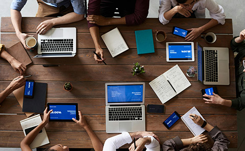 Office workers sat round table