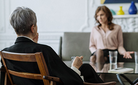 Back of woman in chair with woman.