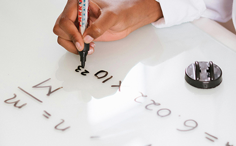 Chemist writing equations on paper