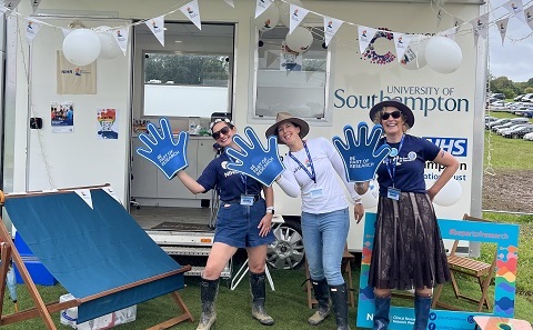 Three people by the research bus