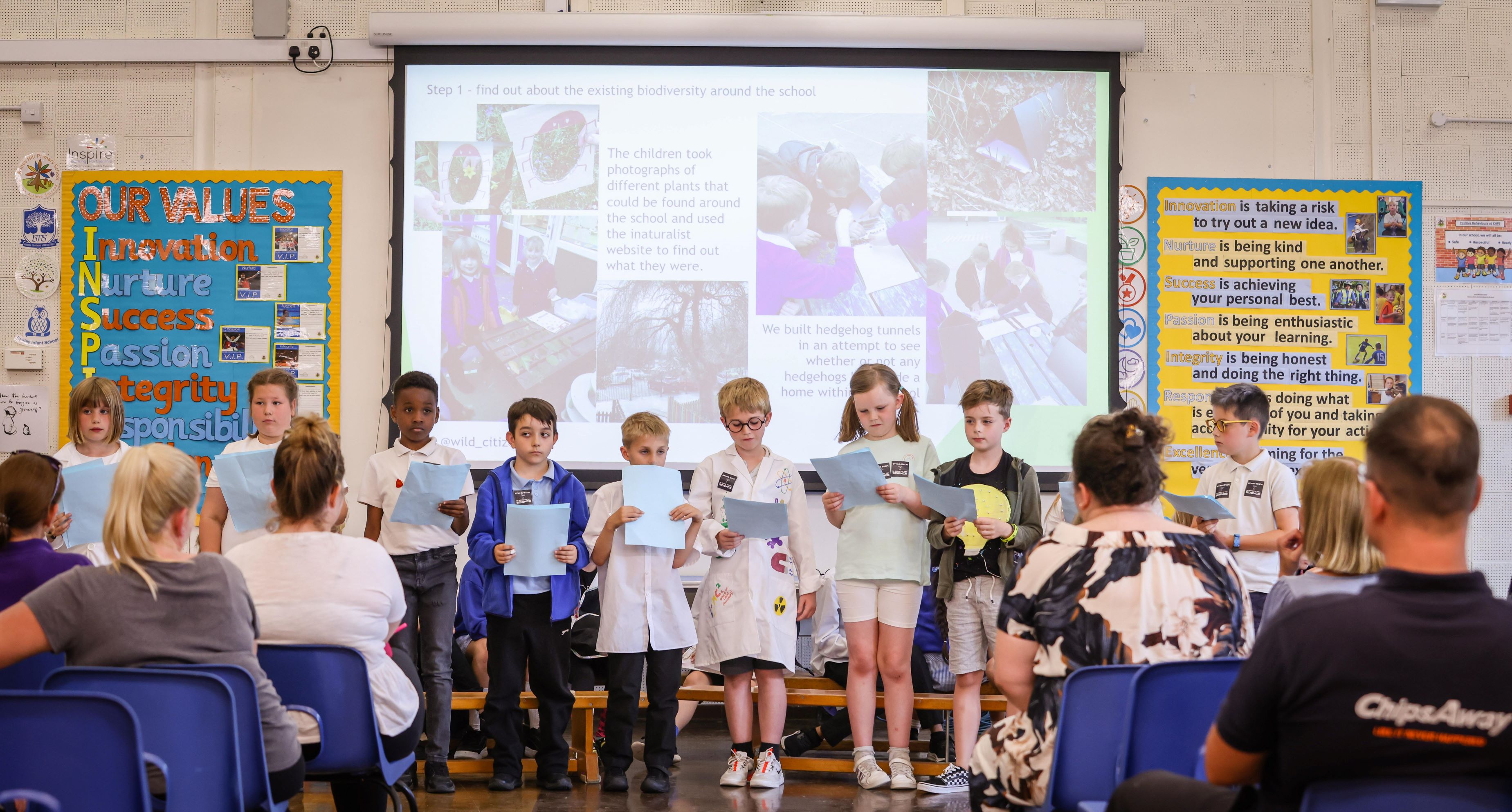 Children presenting their findings to parents
