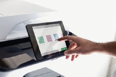 Someone using the touch screen interface of a printer