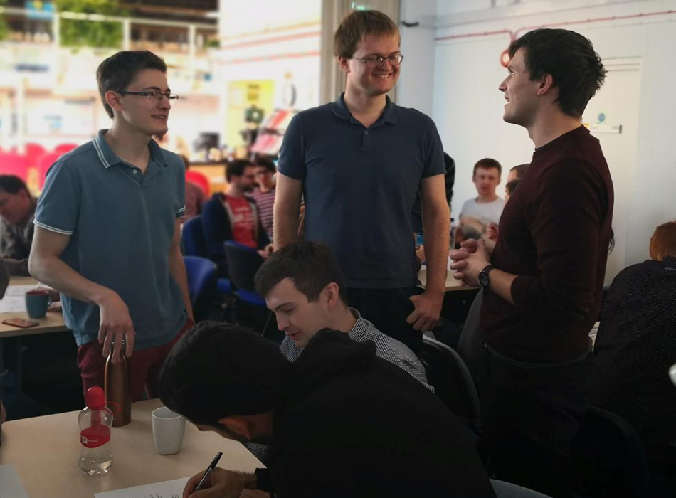 PhD students working on puzzles between talks