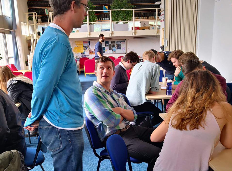Dr. Andreas Schmitt chatting with students 