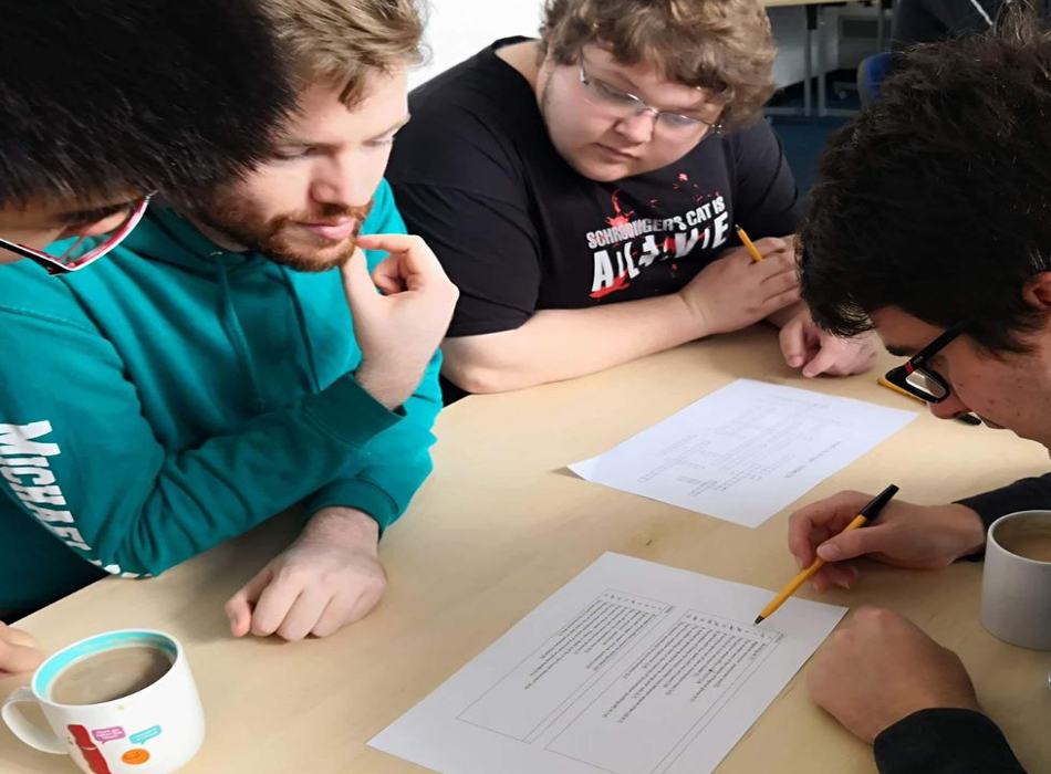 First year students George, Michael, and Peter having a go at the crossword