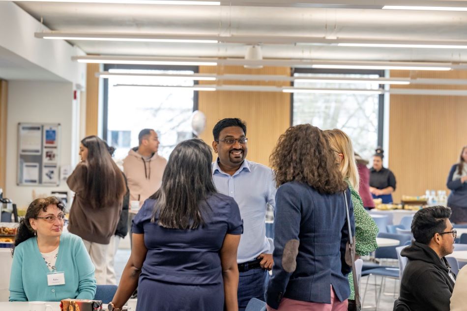 Group of students and alumni talking