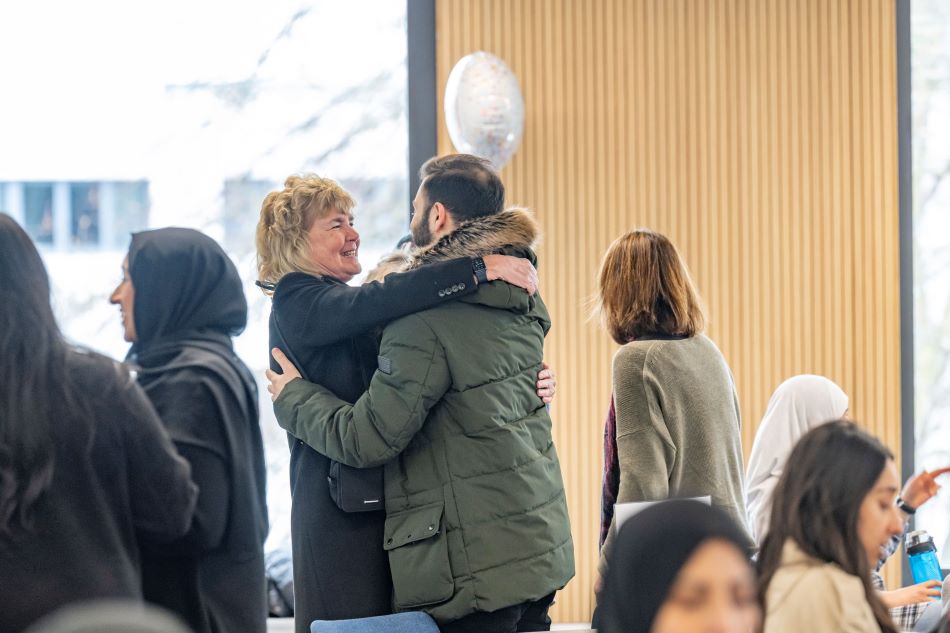 Member of staff greeting former student