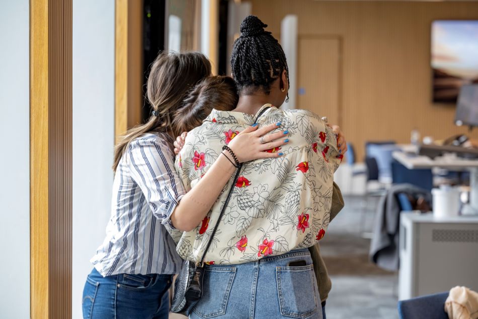Group of former students hugging
