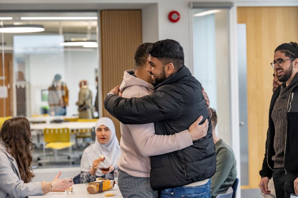 2 former students hugging