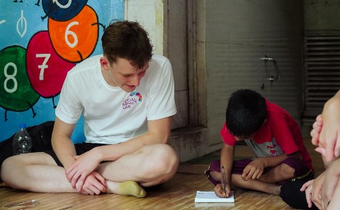 A student playing with children