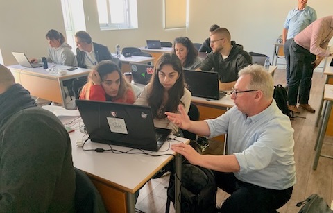 Students with laptops in classroom