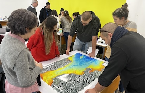 Students watching a bathymetry map 