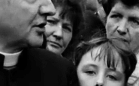 Group of people and a priest