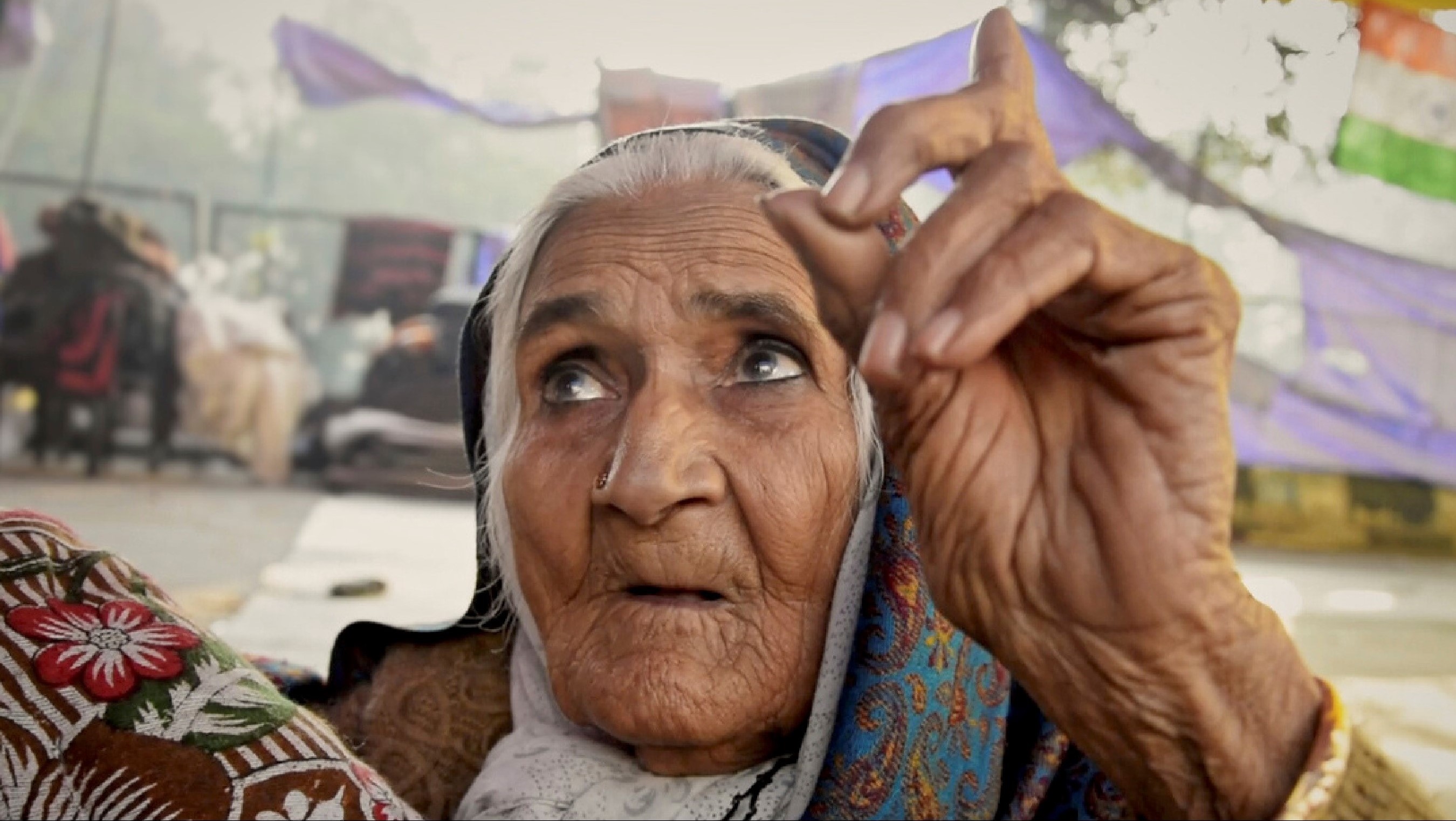 A Muslim woman pointing to the sky