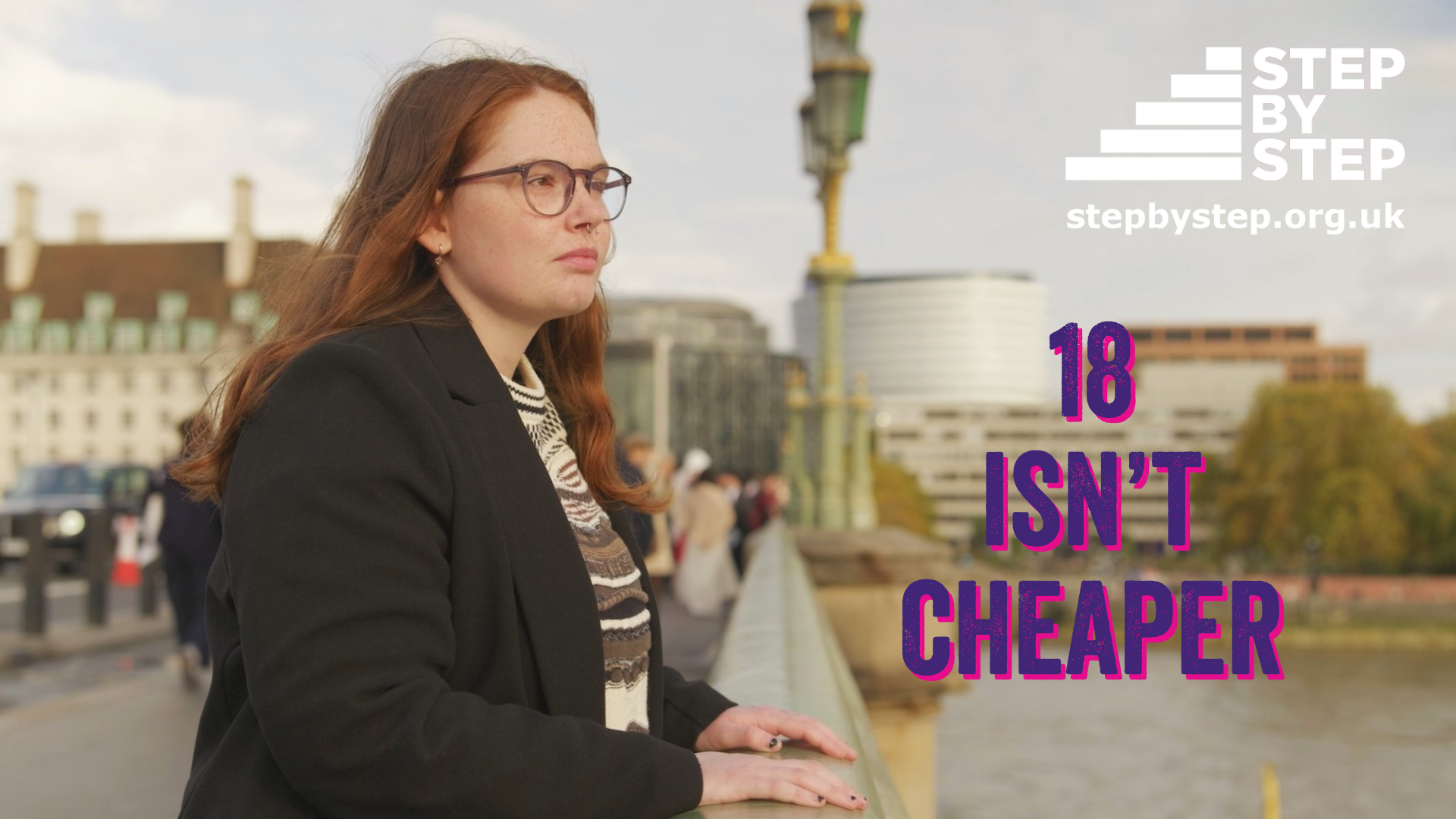 A young woman with long reddish-brown hair and glasses leans on the railing of a bridge, looking thoughtfully into the distance. She wears a black coat and patterned scarf. In the background are city buildings and the river. On the right side of the image, large text reads 