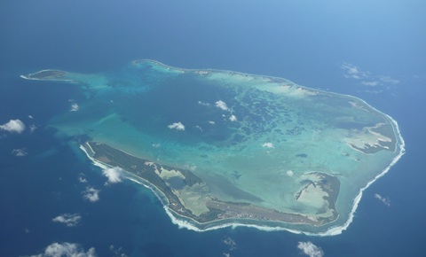 Aerial photograph of an island surrounded by blue ocean