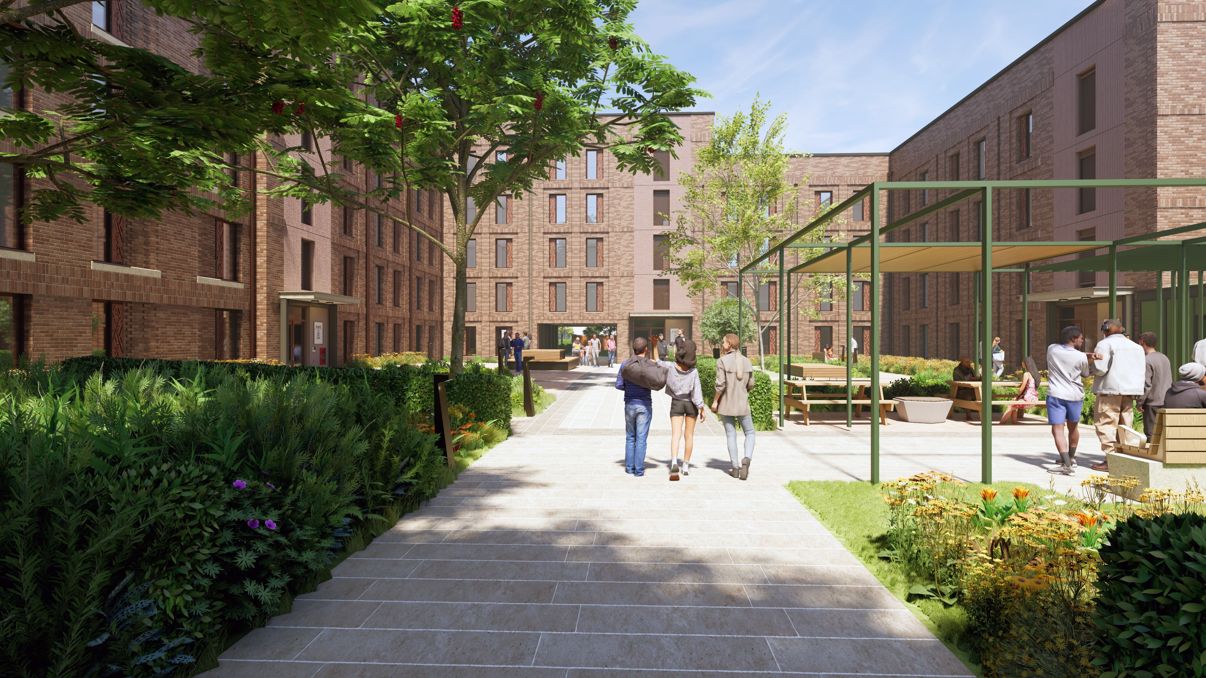A courtyard walkway with landscaped planting, seating areas, and people walking between modern brick buildings