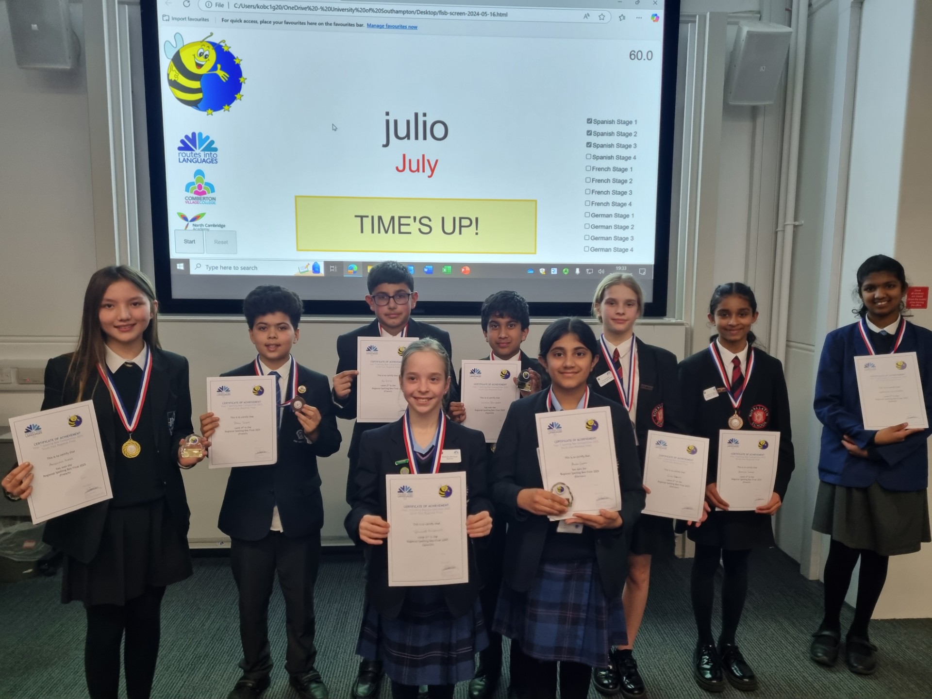 Nine school pupils holding certificates.