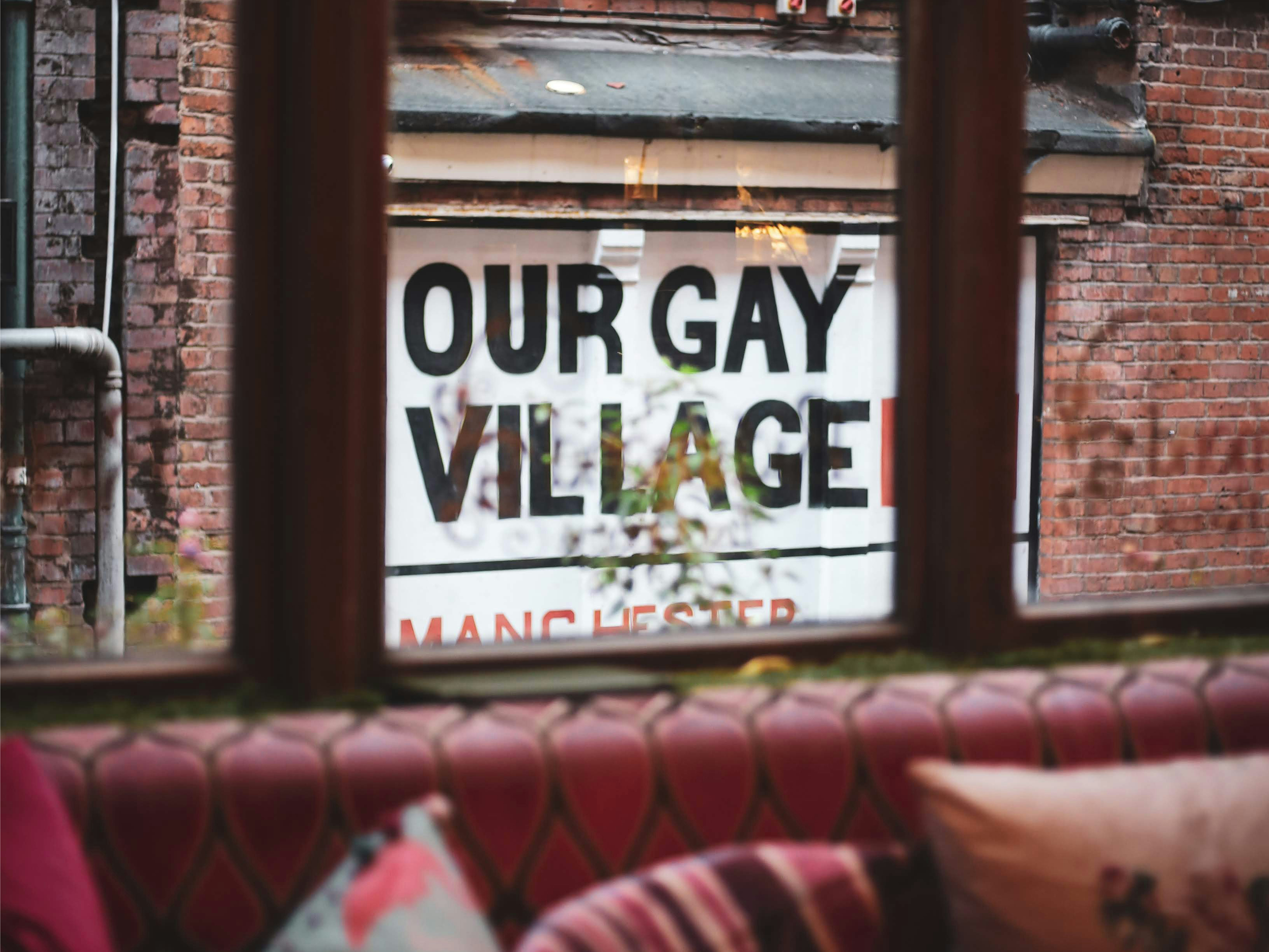 View through a window of a brick building with a large sign reading 